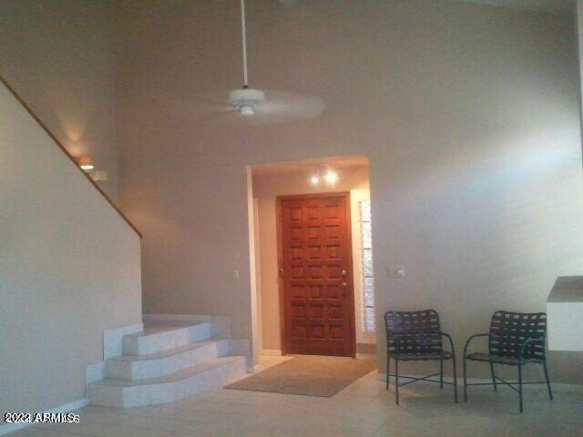 interior space featuring tile patterned floors and ceiling fan