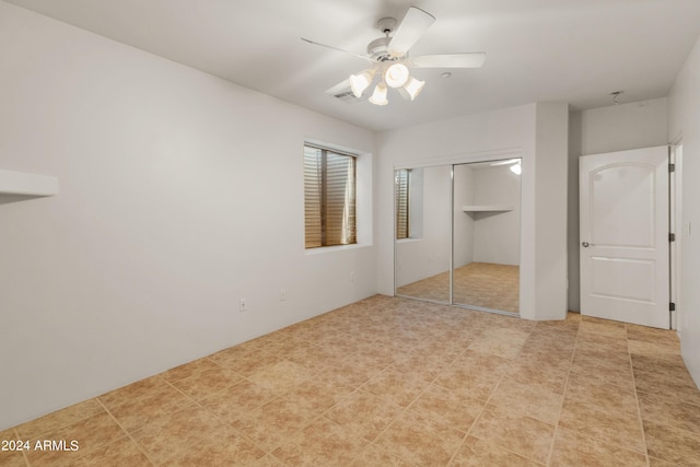 unfurnished bedroom featuring a closet and ceiling fan