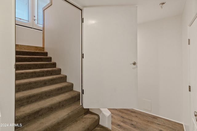 stairs with wood-type flooring