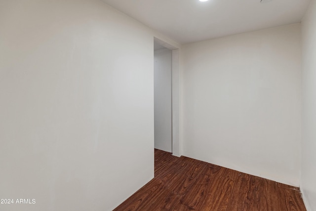 spare room with dark wood-type flooring