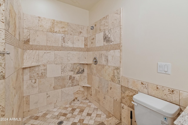 bathroom with tiled shower and toilet