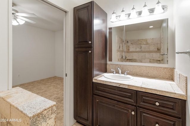 bathroom featuring ceiling fan, vanity, tasteful backsplash, and tile patterned flooring