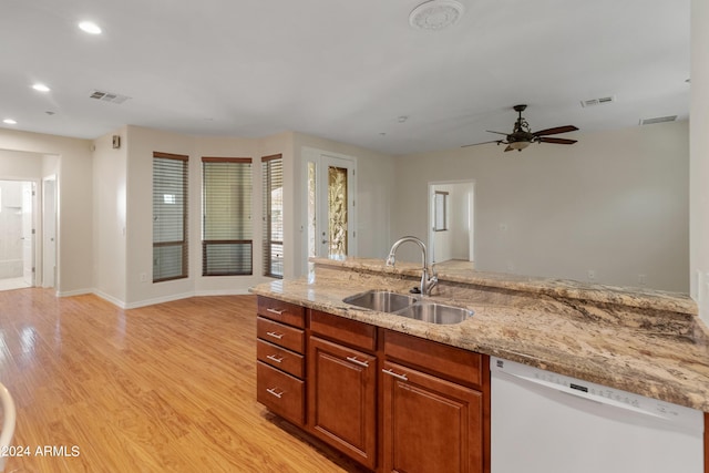 kitchen featuring dishwasher, light stone counters, ceiling fan, light hardwood / wood-style floors, and sink