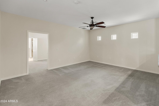 spare room featuring light colored carpet and ceiling fan