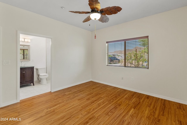 unfurnished bedroom featuring light wood-type flooring, sink, and connected bathroom