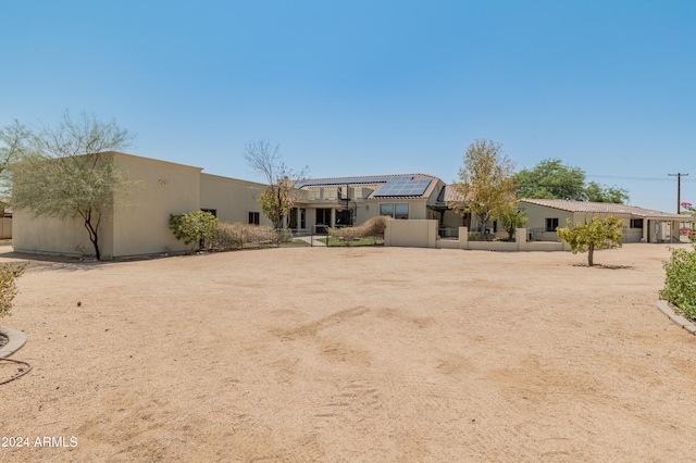 view of front of home featuring solar panels