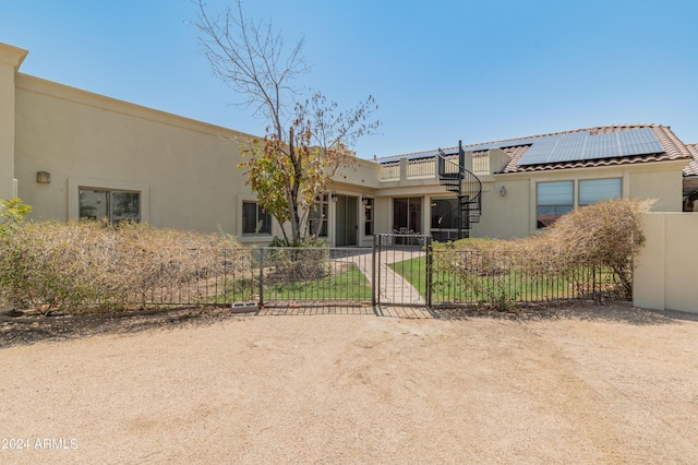 view of front of property featuring solar panels