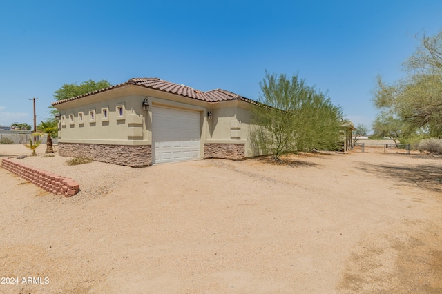 view of side of home with a garage