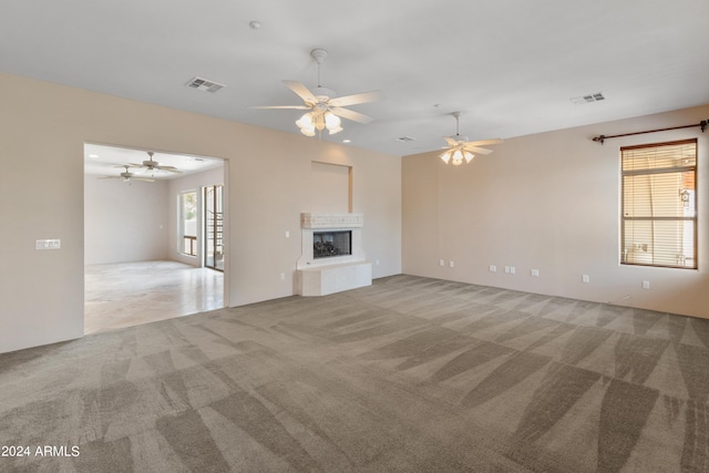 unfurnished living room with a multi sided fireplace and light carpet