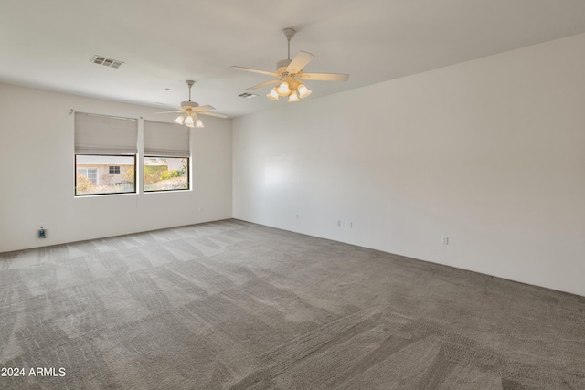 spare room featuring ceiling fan and light carpet