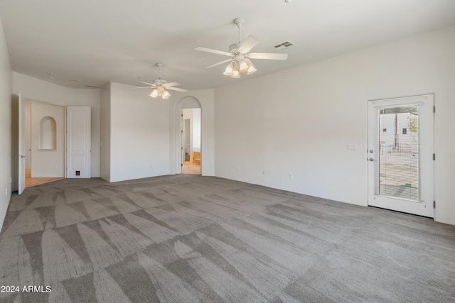 carpeted spare room featuring ceiling fan