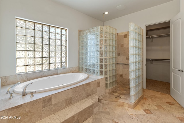 bathroom featuring separate shower and tub