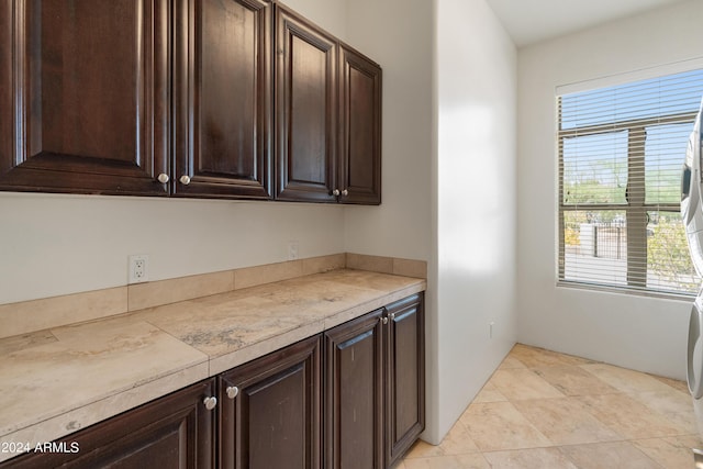 kitchen featuring plenty of natural light and dark brown cabinetry