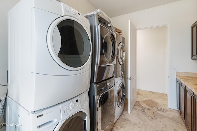 clothes washing area featuring stacked washer / dryer