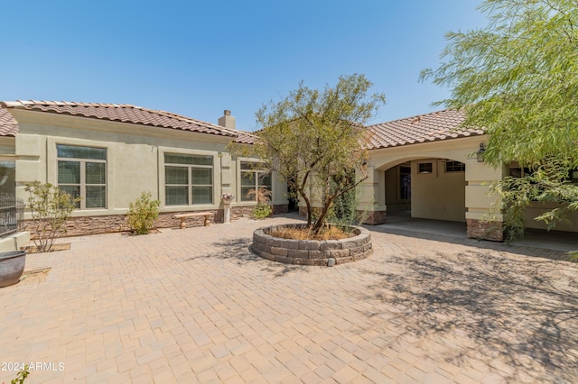 rear view of property featuring a patio area