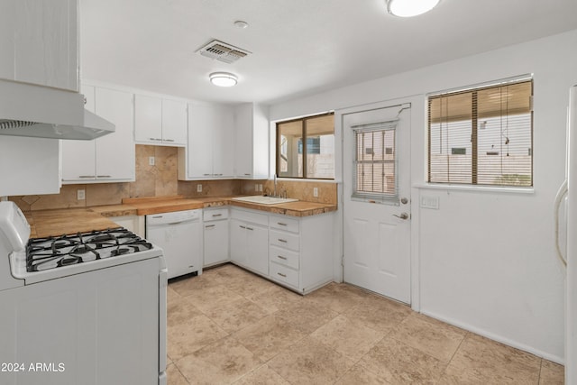 kitchen featuring white appliances, white cabinetry, sink, and decorative backsplash