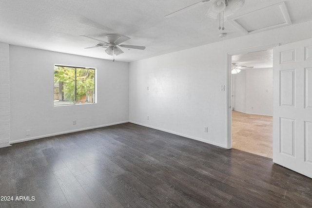 unfurnished room featuring ceiling fan and dark wood-type flooring