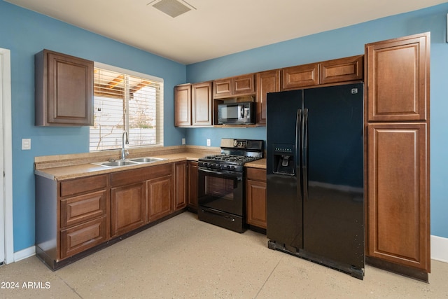 kitchen featuring sink and black appliances