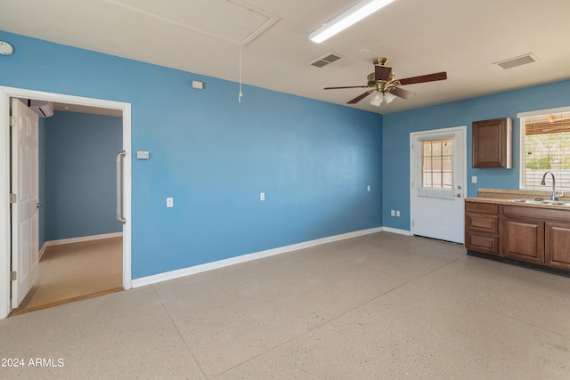 interior space with ceiling fan and sink