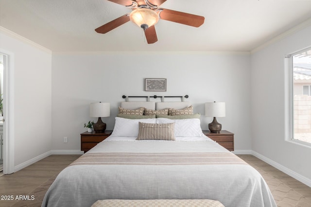 bedroom featuring multiple windows, ornamental molding, light wood finished floors, and baseboards