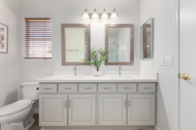 full bathroom with toilet and double vanity