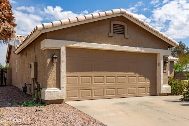 garage featuring concrete driveway