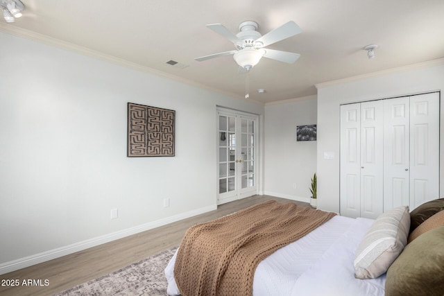 bedroom featuring french doors, wood finished floors, crown molding, baseboards, and ceiling fan