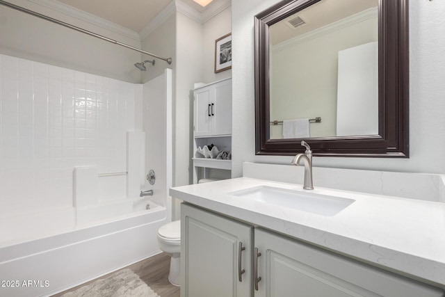 full bathroom with crown molding, toilet, vanity, wood finished floors, and bathing tub / shower combination