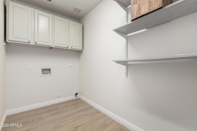 washroom with washer hookup, baseboards, light wood finished floors, cabinet space, and gas dryer hookup