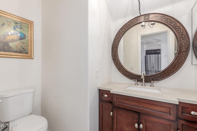 bathroom featuring vanity and toilet