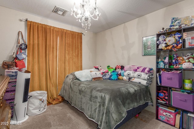 bedroom featuring a textured ceiling, a chandelier, and carpet floors