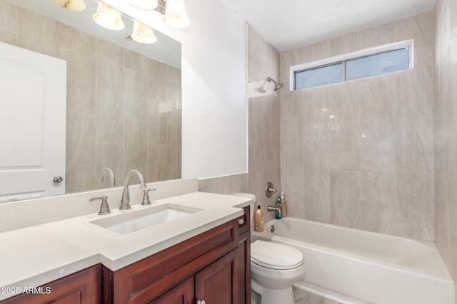 full bathroom with tiled shower / bath combo, toilet, and vanity