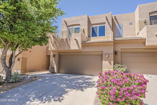 11752 N 135th Pl, Scottsdale, AZ 85259 - southwest-style home with an attached garage, a balcony, concrete driveway, and stucco siding