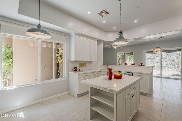 11752 N 135th Pl, Scottsdale, AZ 85259 - kitchen with visible vents, light tile patterned floors, a sink, a peninsula, and tasteful backsplash