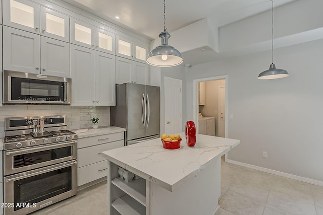 11752 N 135th Pl, Scottsdale, AZ 85259 - kitchen featuring tasteful backsplash, a center island, separate washer and dryer, stainless steel appliances, and white cabinets