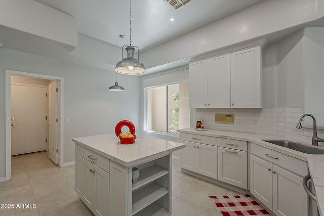 11752 N 135th Pl, Scottsdale, AZ 85259 - kitchen featuring light stone counters, open shelves, a sink, decorative light fixtures, and backsplash