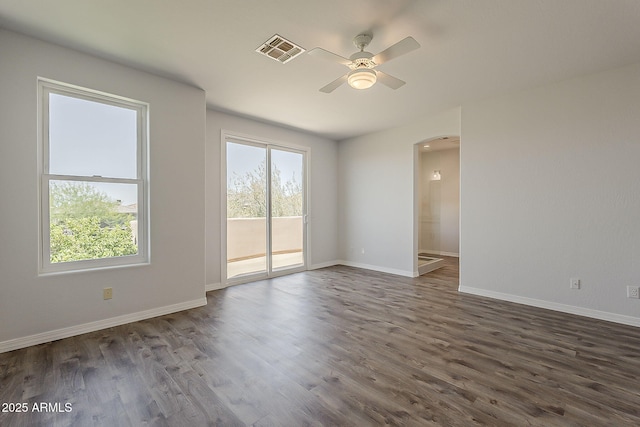 11752 N 135th Pl, Scottsdale, AZ 85259 - spare room with dark wood-style floors, visible vents, a ceiling fan, arched walkways, and baseboards