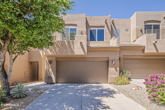 11752 N 135th Pl, Scottsdale, AZ 85259 - view of front facade with stucco siding, concrete driveway, a balcony, and a garage