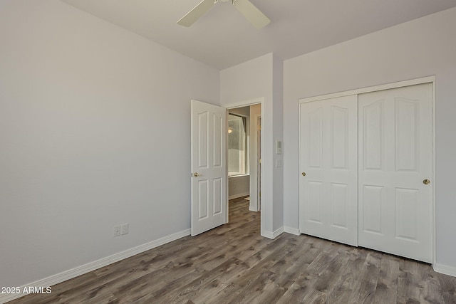 11752 N 135th Pl, Scottsdale, AZ 85259 - unfurnished bedroom featuring a ceiling fan, baseboards, a closet, and dark wood-style flooring