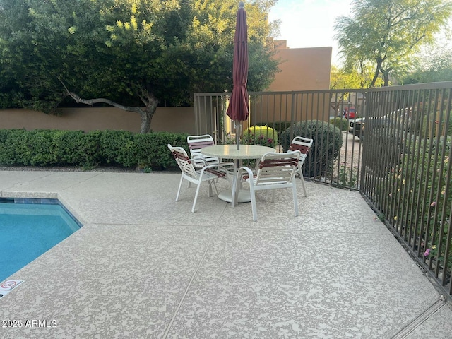 11752 N 135th Pl, Scottsdale, AZ 85259 - view of patio / terrace featuring outdoor dining area, fence, and a fenced in pool