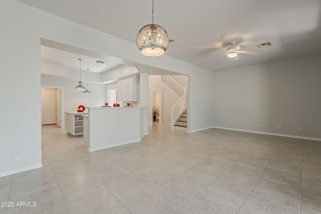 11752 N 135th Pl, Scottsdale, AZ 85259 - unfurnished living room featuring baseboards, visible vents, stairs, ceiling fan, and light tile patterned floors