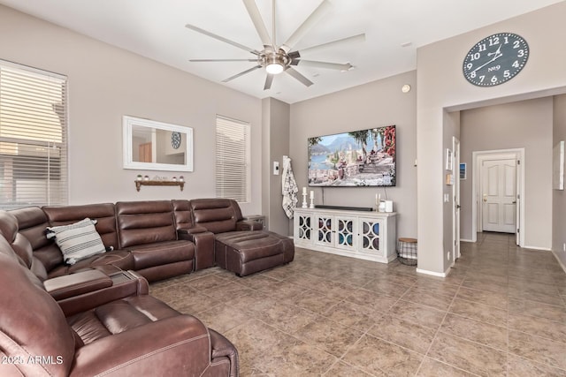 living room featuring ceiling fan and tile patterned floors