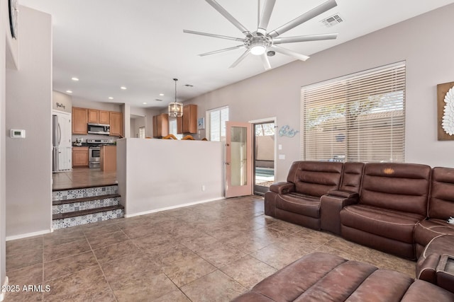 living room featuring light tile patterned floors and ceiling fan