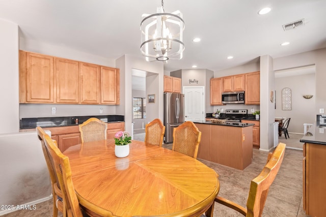 tiled dining space featuring a chandelier