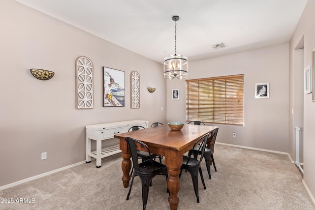 dining area featuring an inviting chandelier and light colored carpet