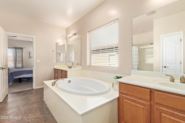 bathroom featuring vanity, tile patterned flooring, and separate shower and tub