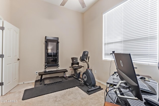 exercise room featuring light carpet and ceiling fan