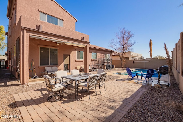 exterior space with a fenced in pool and a patio area