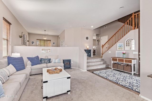 carpeted living room with a wood stove