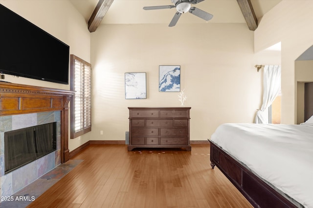 bedroom featuring multiple windows, ceiling fan, and beamed ceiling